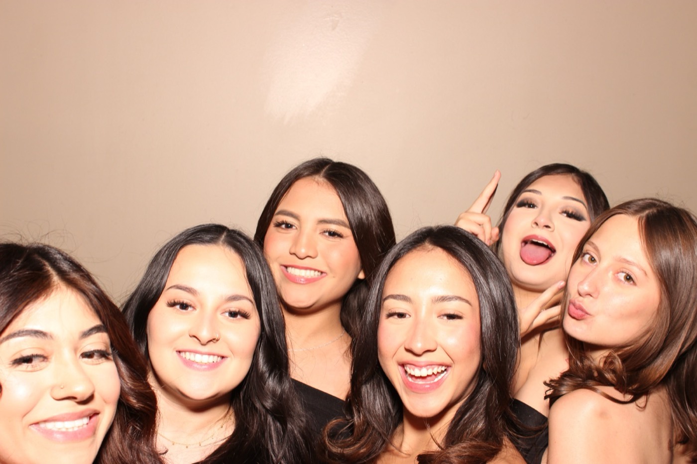 A close group of friends smiling at a formal dance in San Antonio