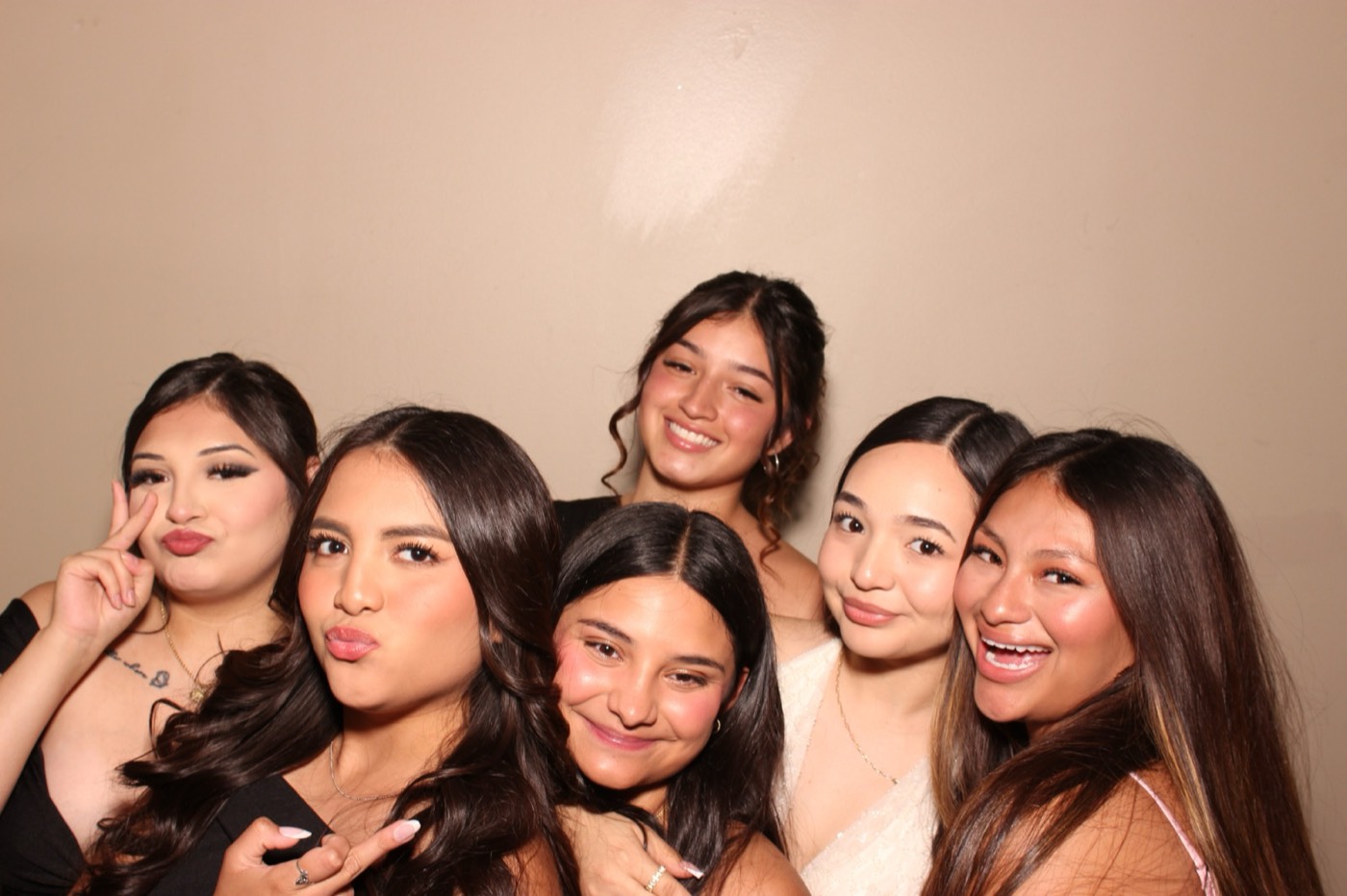 A group of friends striking a pose at a formal dance in San Antonio