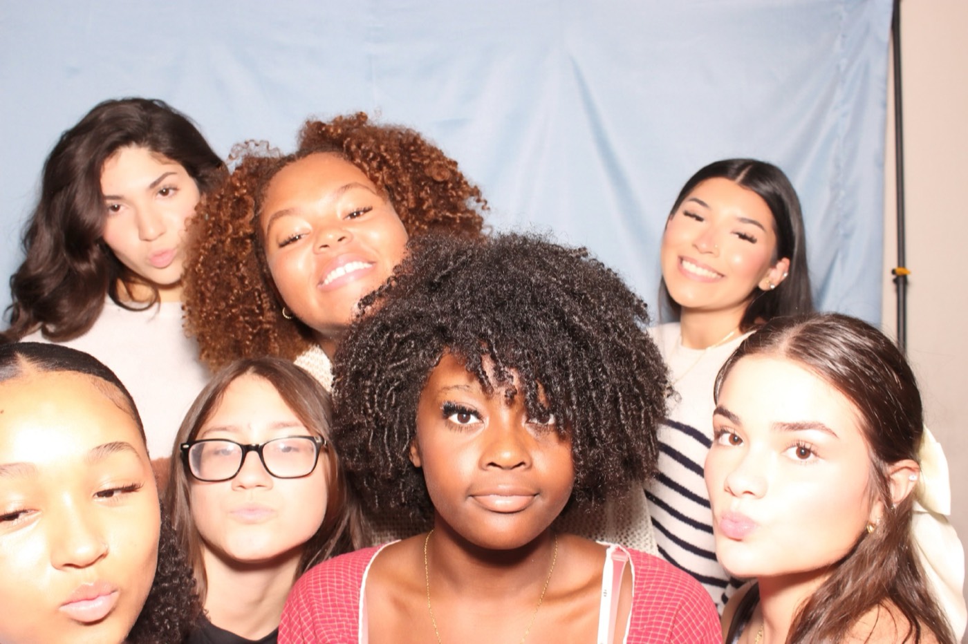 Friends crowding into the frame at a house party in San Antonio