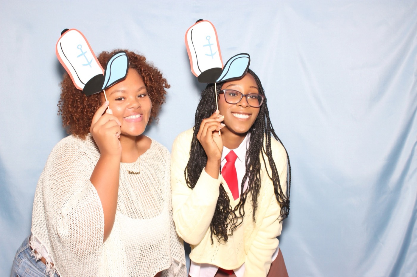 Two friends with bunny ear props at a house party in San Antonio