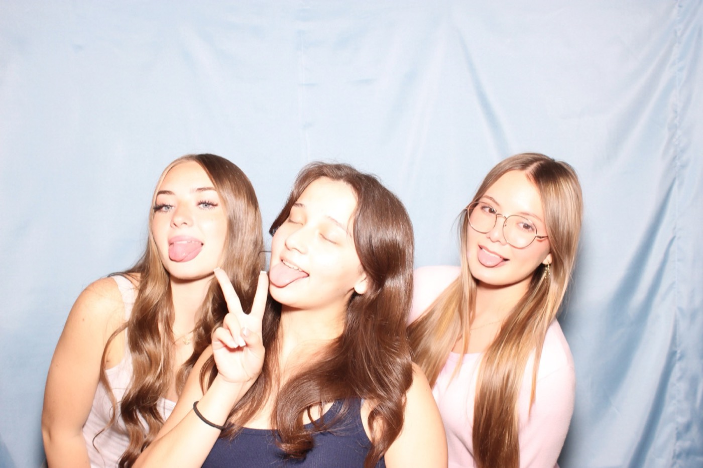 Friends sticking their tongues out at a house party in San Antonio