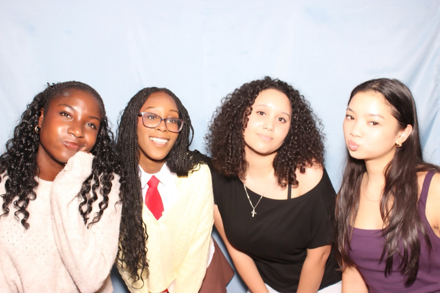Four friends posing together at a house party in San Antonio