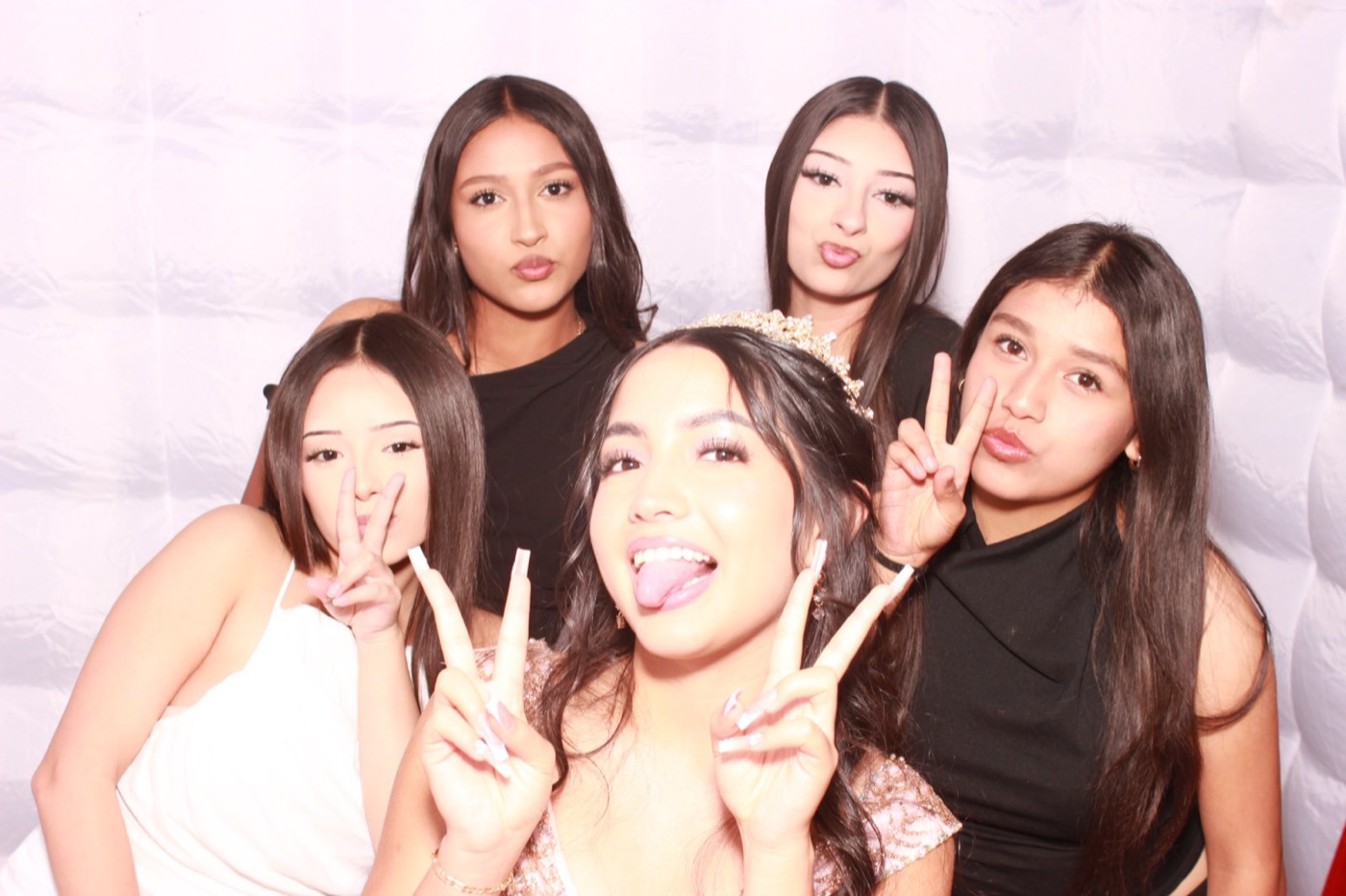 The quinceañera and her friends making silly faces at a quince party in San Antonio