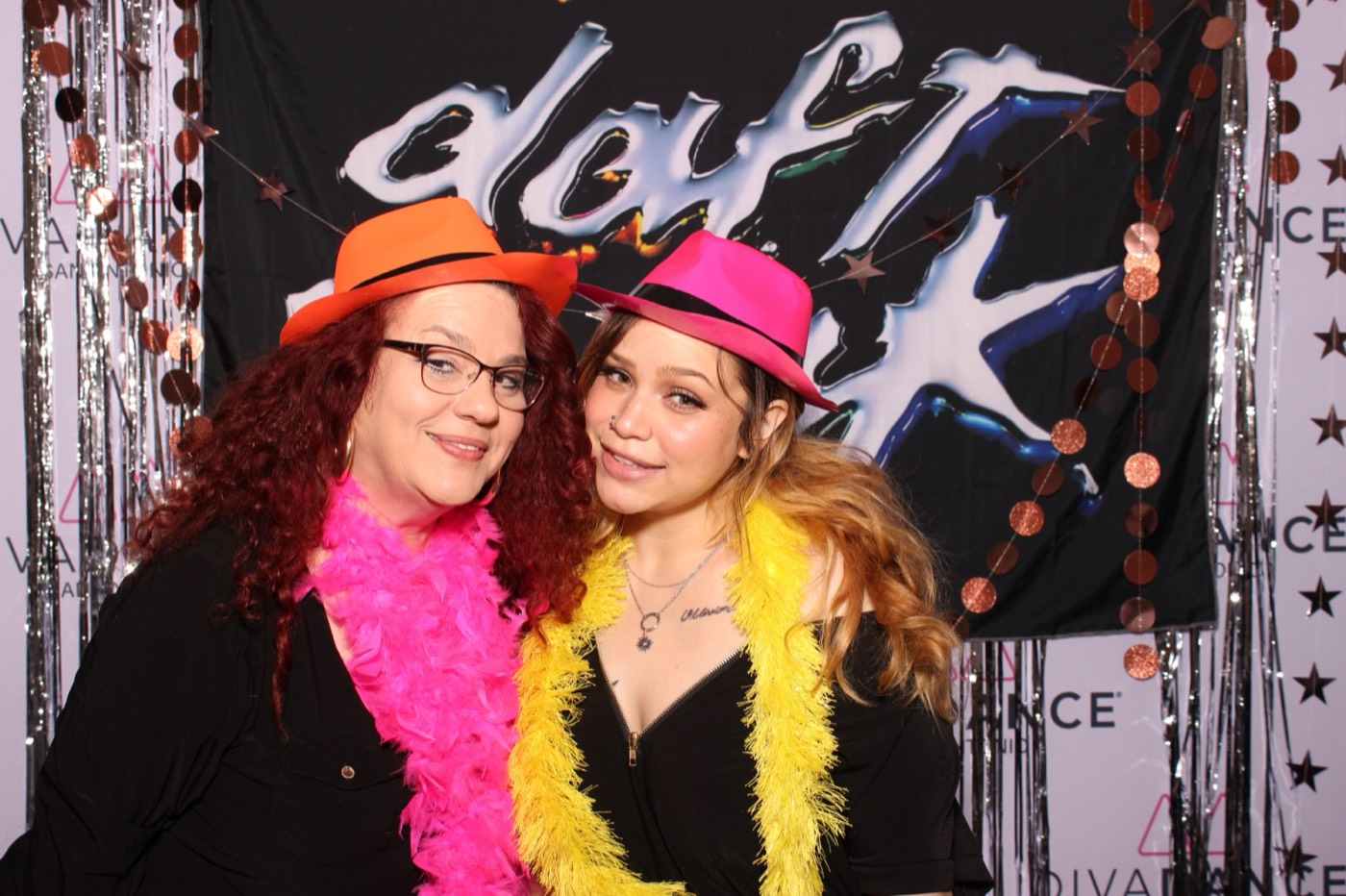Two friends in a pink hat and boas at a Daft Punk themed birthday party