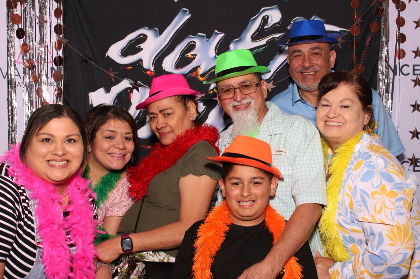 A family in party hats and boas at a Daft Punk themed birthday party
