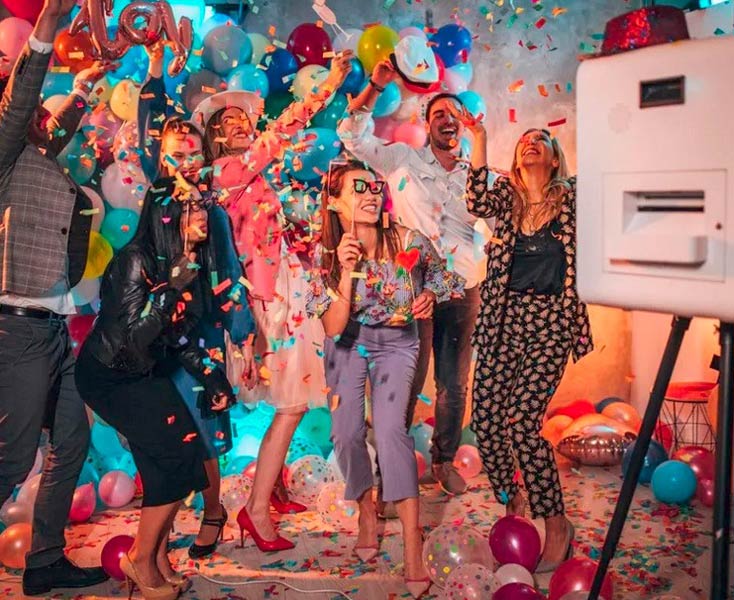 Guests celebrating with a photo booth at a San Antonio event; Mr Booth provides fun, instant-print rentals for weddings and parties.
