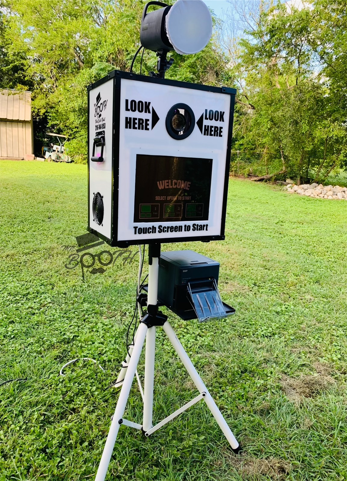 Outdoor photo booth setup by Mr Booth in San Antonio, featuring the PartyPic photo booth rental system.